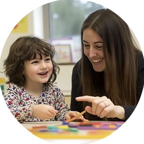 A young child and a clinician playing with coloured blocks